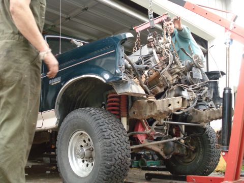 1993 Ford Bronco - Engine removal in progress on a 1993 Ford Bronco using an engine hoist.
