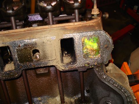 1993 Ford Bronco - Close-up of an engine block showing dirty intake ports and corrosion on an exhaust port.