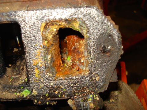 1993 Ford Bronco - Close-up of a severely rusted engine part, likely from a cooling system failure.