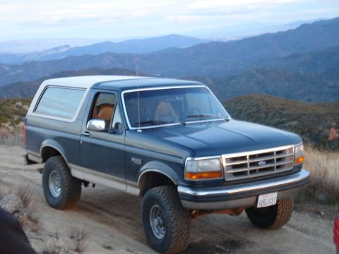 1993 Ford Bronco - This 1993 Ford Bronco is seen on a dirt road with a mountainous landscape behind it.