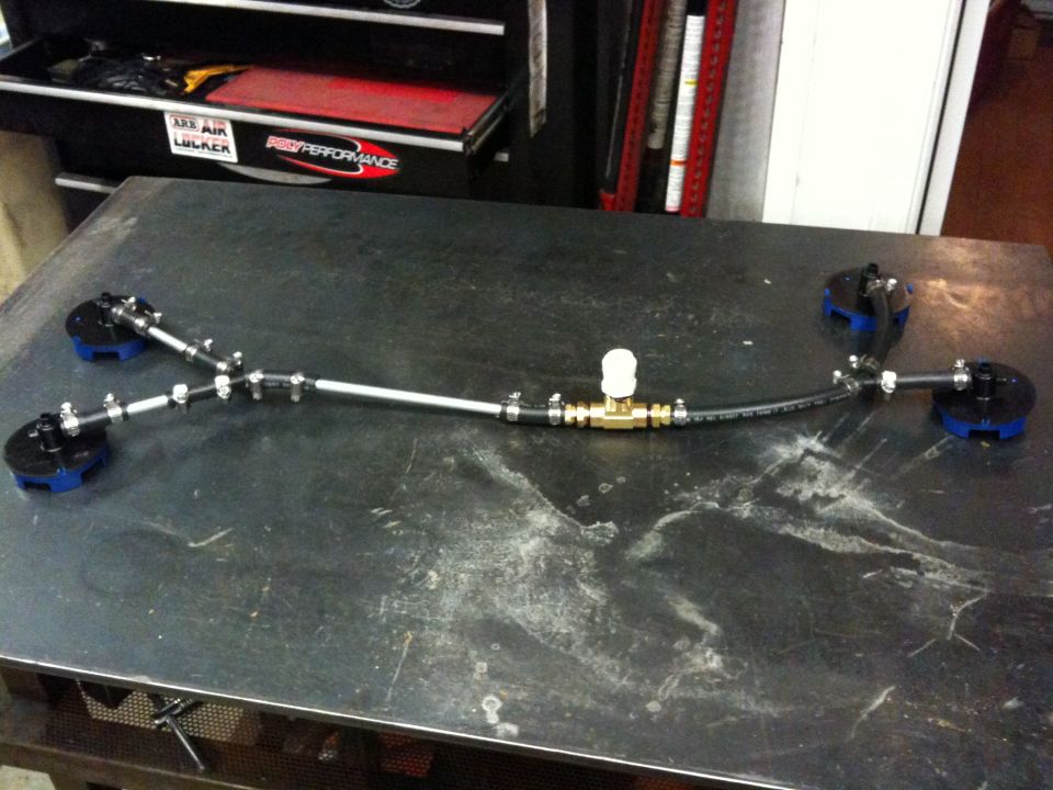 custom fuel line with brass fittings and blue-capped ends