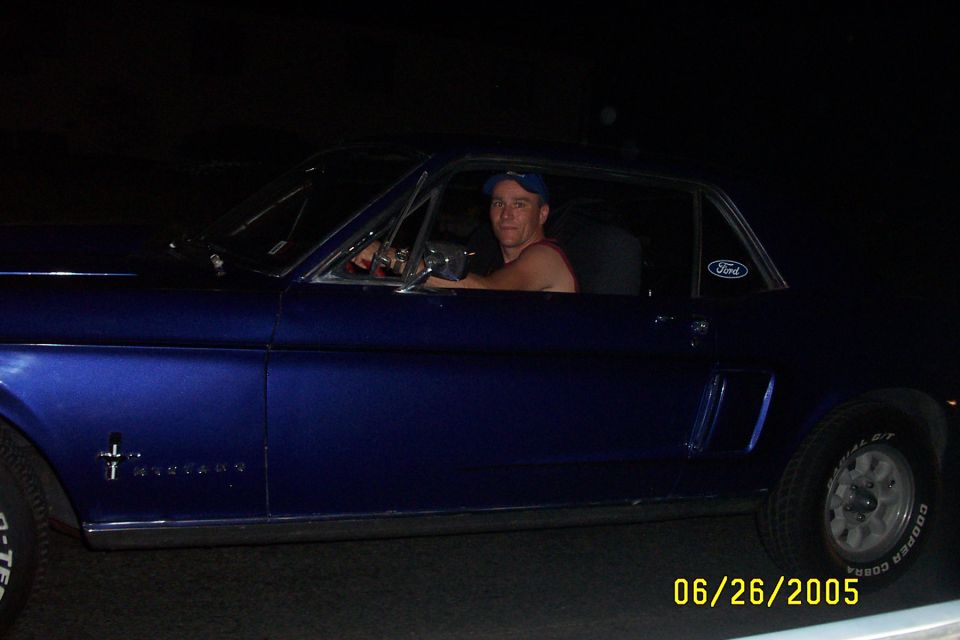 Blue 1967 Ford Mustang coupe side view with driver