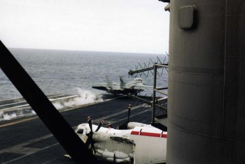 1999 Ford Crown Victoria - Two aircraft on an aircraft carrier deck at sea.
