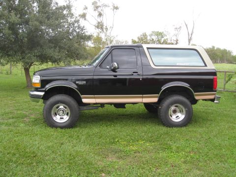 1994 Ford Bronco - Side view of a lifted 1994 Ford Bronco with aftermarket wheels and tires.