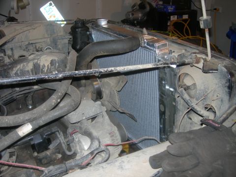 1991 Jeep Wrangler - Close-up view of a vehicle's engine bay, focusing on the radiator and cooling fan assembly.
