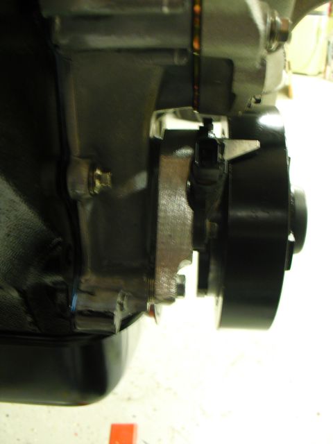 1996 Ford Bronco - Detail of an engine component, likely a pulley and sensor, with metallic and black finishes.