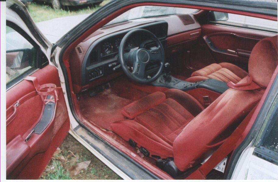 1988 Ford Thunderbird interior with red velour seats and dashboard