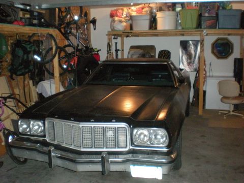 1974 Ford Ranchero - Front view of a 1974 Ford Ranchero parked inside a garage with storage shelves above.