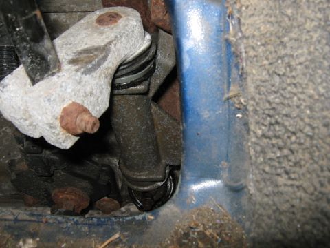 1996 Ford F-150 - Undercarriage view of a vehicle's suspension system, showing a worn component.
