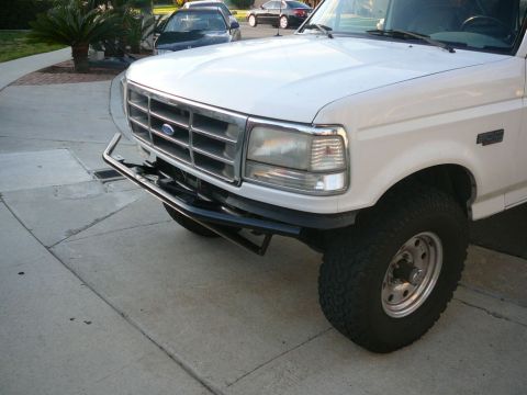 1988 Ford Bronco - This Ford F-Series truck features a chrome grille and a custom front bumper.