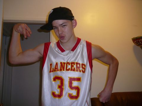 1988 Ford Bronco - A young person poses for a photo while wearing a basketball jersey and cap.