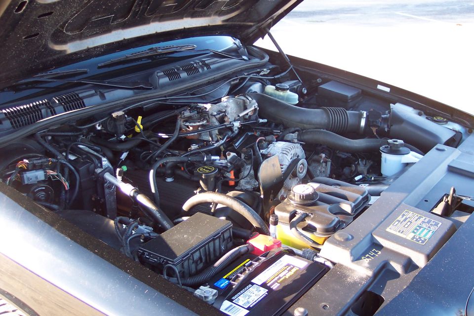 Engine bay with battery and various components visible