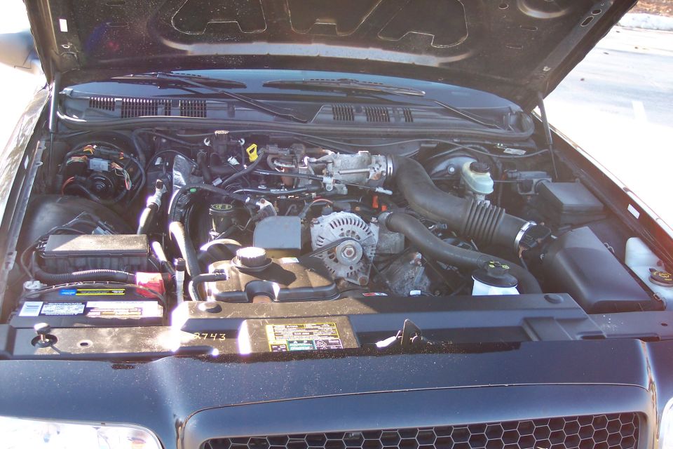 2001 Ford Crown Victoria engine bay with hood open, showing engine components and battery