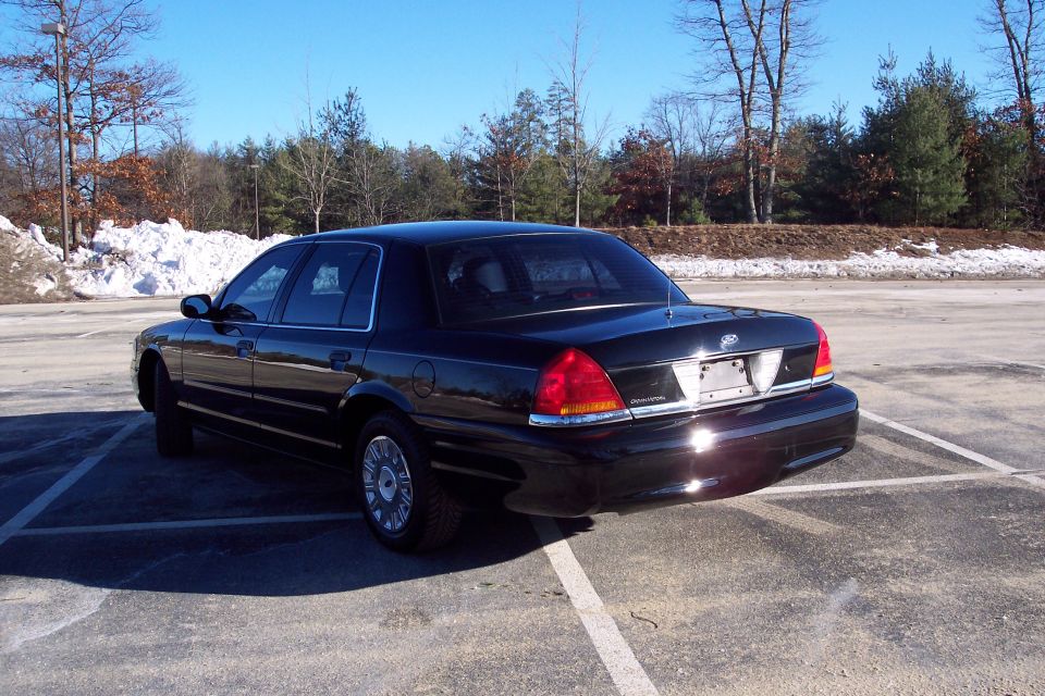 Black 2001 Ford Crown Victoria parked in a lot, rear-right view
