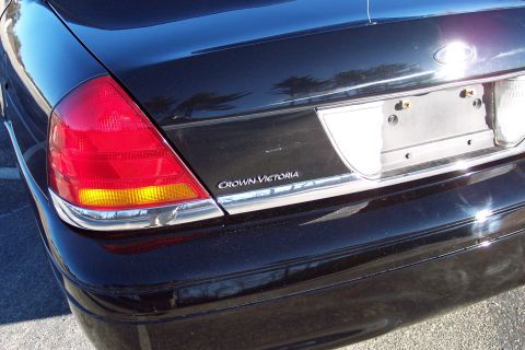 2001 Ford Crown Victoria - The rear of a black Ford Crown Victoria is shown, highlighting the taillight and model name.