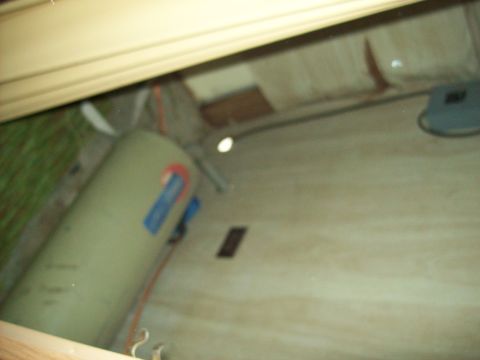 1985 Ford Bronco - The interior of a vehicle is shown, a large cylindrical tank and "SUPERMOTORS" branding at the bottom right.