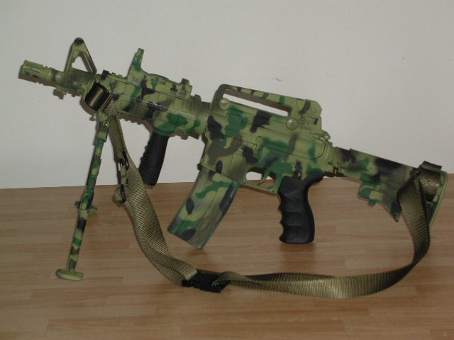 toy assault rifle with camouflage pattern and bipod