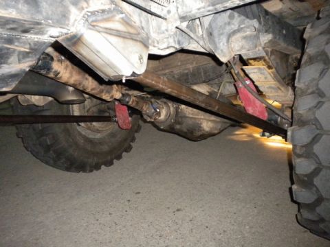 1989 Ford Bronco - The photo shows the undercarriage of a vehicle, focusing on the drivetrain and suspension parts.