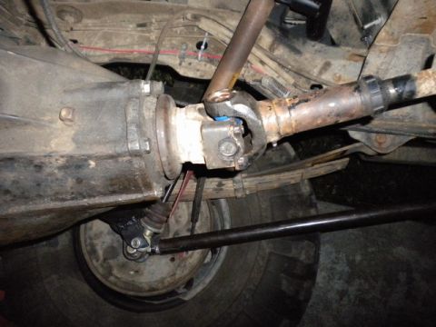 1989 Ford Bronco - Close-up view of the driveshaft and differential assembly, showing mechanical components and leaf springs.