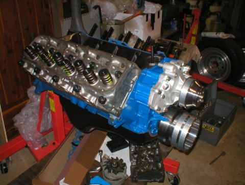 1978 Ford Bronco - Engine components are laid out on an engine stand in a workshop setting.