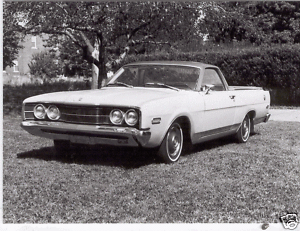 1976 Ford Ranchero - A white coupe from the 1970s is shown from the front, parked outdoors on a grassy area.