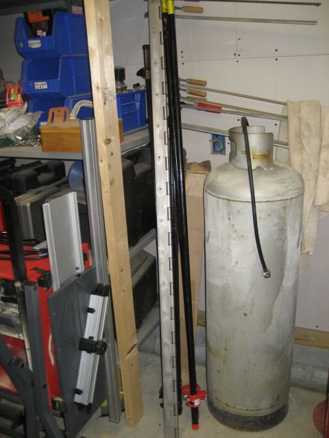 1996 Ford Bronco - A propane tank and assorted tools are stored in a garage.