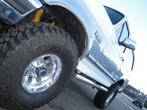 1995 Ford Bronco - This 1995 Ford Bronco features prominent off-road tires and a clear "BRONCO" badge, confirming its identity.