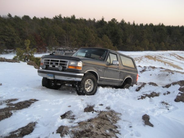 Dark gray 1994 Ford Bronco in snow, front-left 3/4 view