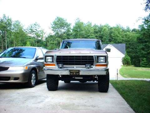 1978 Ford Bronco - This Ford truck, likely from the late 1970s, is parked in a driveway next to another car.