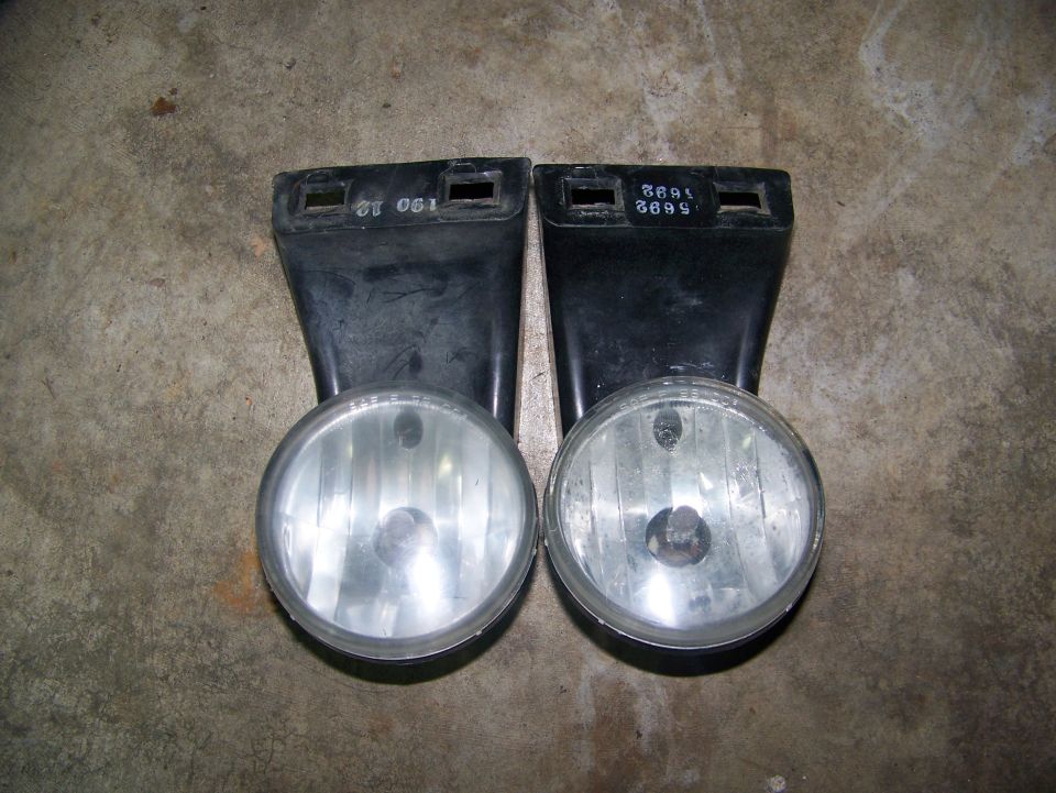 Pair of fog lights with visible part numbers