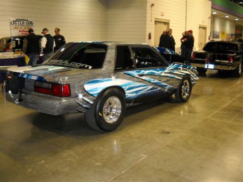 1992 Ford Mustang - Customized 1992 Ford Mustang drag car with unique lightning graphics, seen at an indoor event.