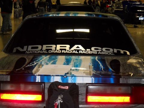 1992 Ford Mustang - Rear view of a car with custom graphics and a large sticker on the back window.