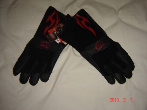 1993 Ford Bronco - These black BSX gloves feature red flame graphics and are shown on a white surface.
