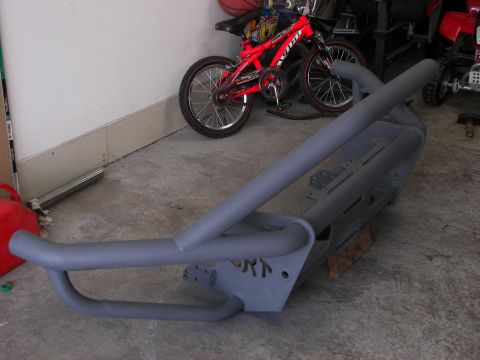 1990 Chevrolet Suburban - A custom gray front bumper with tubing and "ORN" lettering is shown in a garage setting.