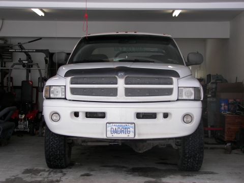 1990 Chevrolet Suburban - This Dodge Ram pickup truck is parked inside a garage, facing the camera directly.
