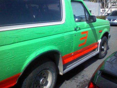 1994 Ford Bronco - This 1994 Ford Bronco is painted green with orange racing stripes and a large number 3.