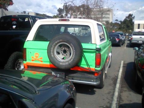 1994 Ford Bronco - This green Ford Bronco has a skull and crossbones decal on its rear quarter panel.