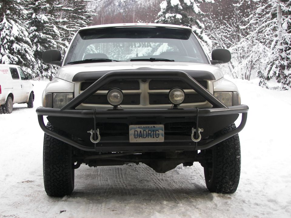 White pickup truck front view with bull bar and Alaska license plate DADRIG