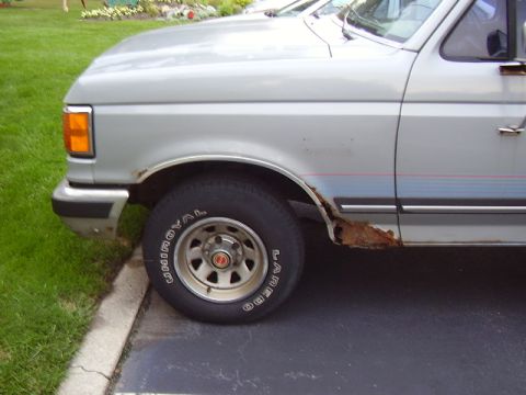 1996 Ford F-150 - This truck shows significant rust damage on its lower body panels.