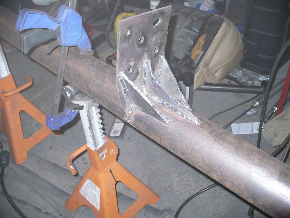 metal pipe held by jack stands with a welded bracket attached