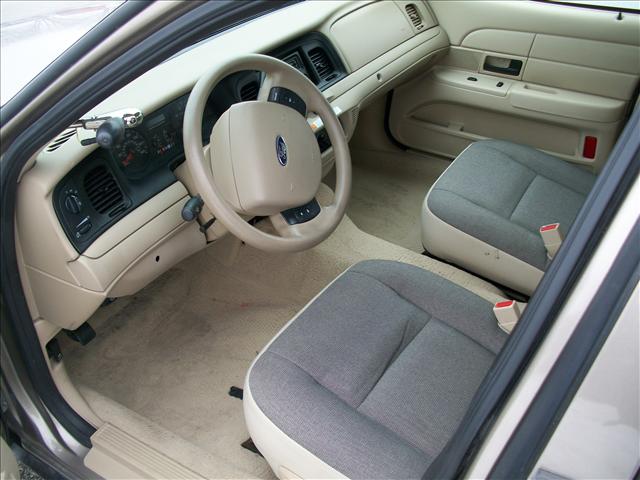 Interior view of a car, showing the dashboard, steering wheel, and front seats