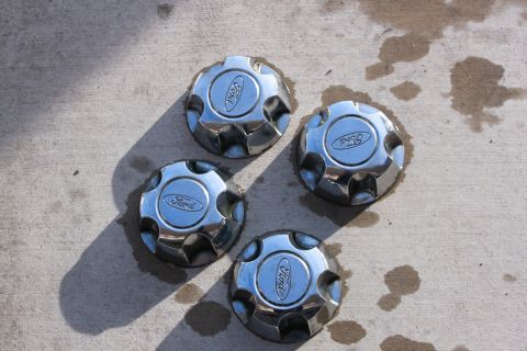 1998 Ford Crown Victoria - Set of four chrome Ford hubcaps, each the iconic Ford oval logo.