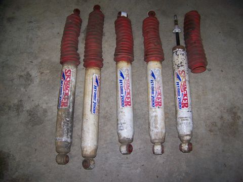 2001 Dodge 1500 - A collection of Skyjacker Hydro 7000 shock absorbers are laid out on a concrete surface.