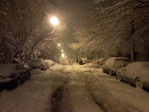 2007 Subaru Impreza - Parked cars are buried in snow on a street during a winter storm.