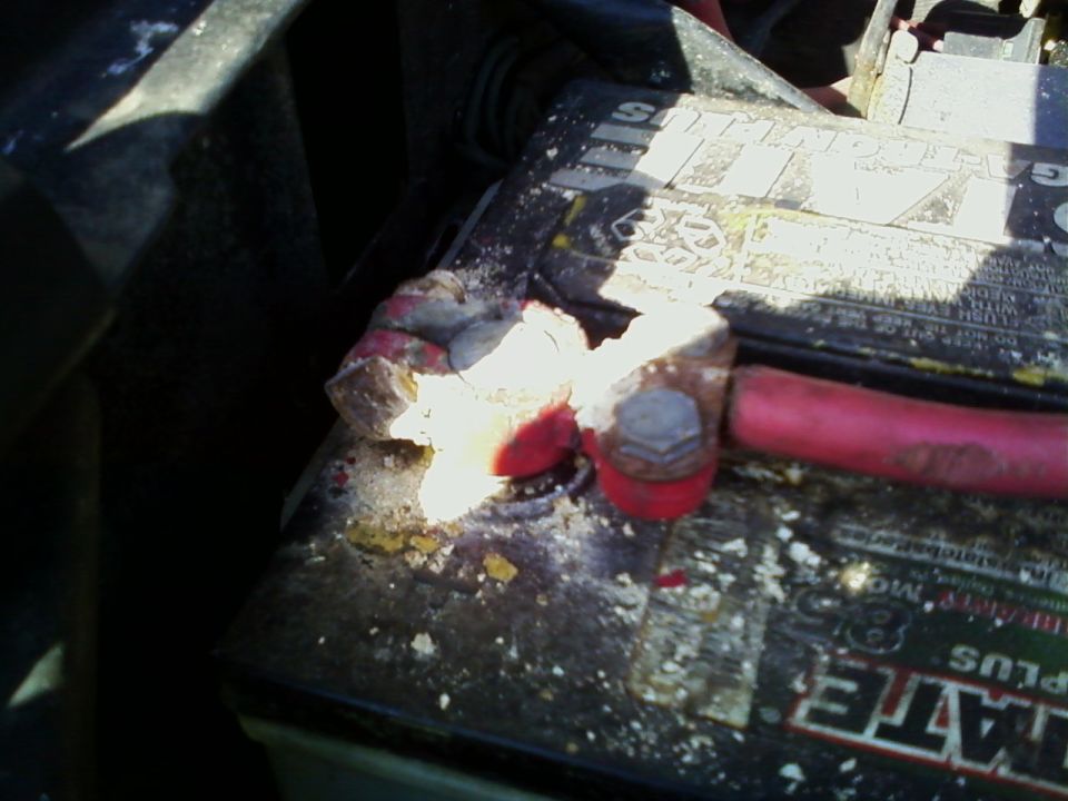 Corroded battery terminal with white and yellow residue
