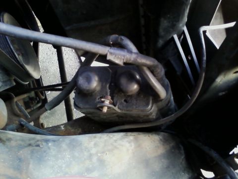 1990 Ford Bronco - This is a close-up view of a vehicle's engine component with attached hoses and wiring.