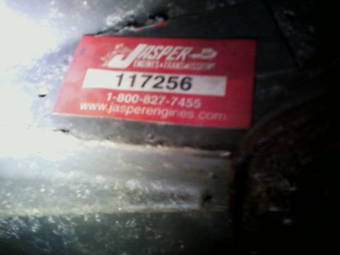 1990 Ford Bronco - A red Jasper Engines & Transmissions sticker is affixed to a dark, grimy surface.
