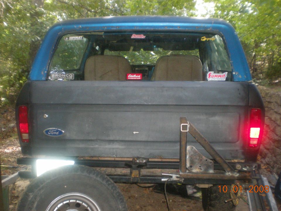 Blue and gray Ford Bronco rear view with "Bronco" sticker on rear window