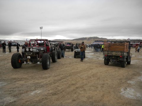 1997 Ford Ranger - Multiple off-road vehicles and a utility vehicle are parked on a dirt lot with spectators in the background.