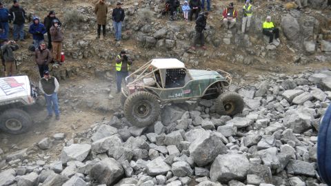 1997 Ford Ranger - Off-road buggy navigates a rocky terrain with spectators watching.